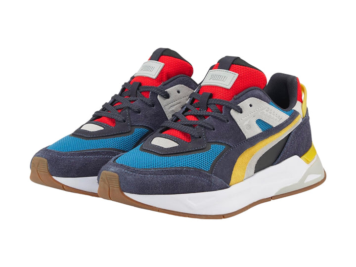 Tenis PUMA Mirage Sport Layers multicolor con detalles en azul, amarillo y rojo sobre suela blanca.