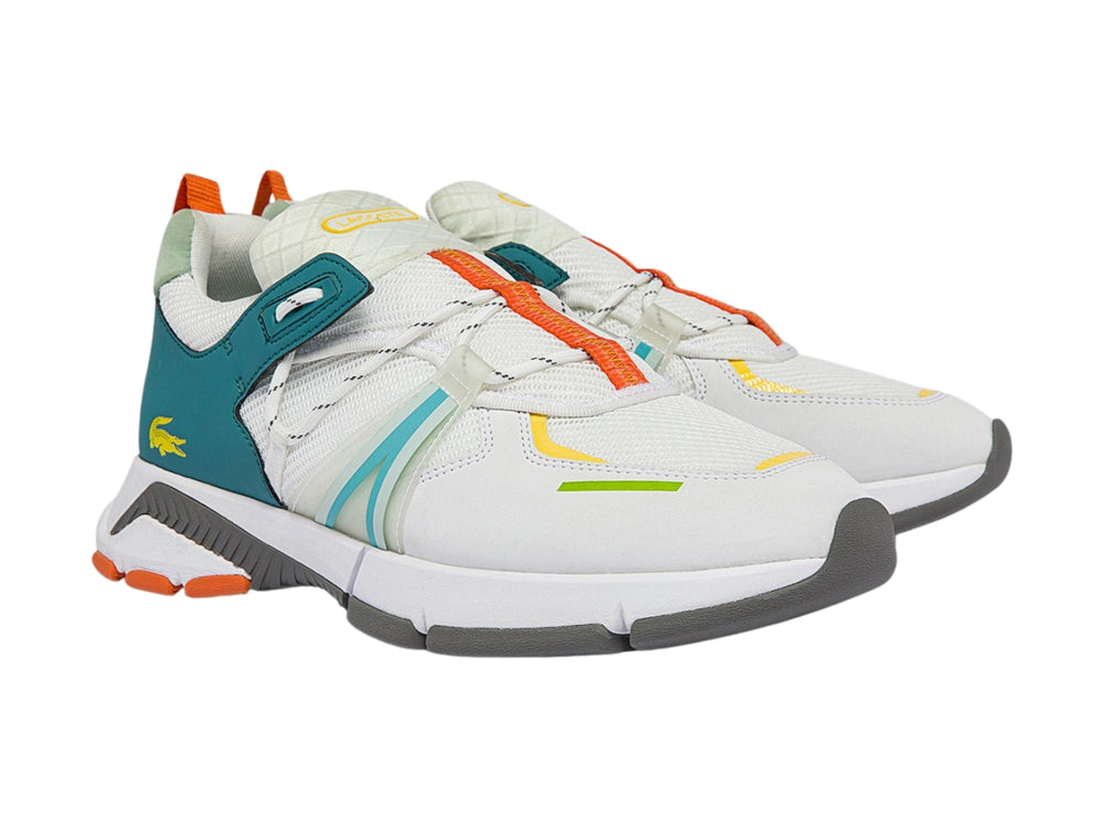 Tenis deportivos Lacoste blancos con detalles en azul turquesa y naranja sobre suela gris.