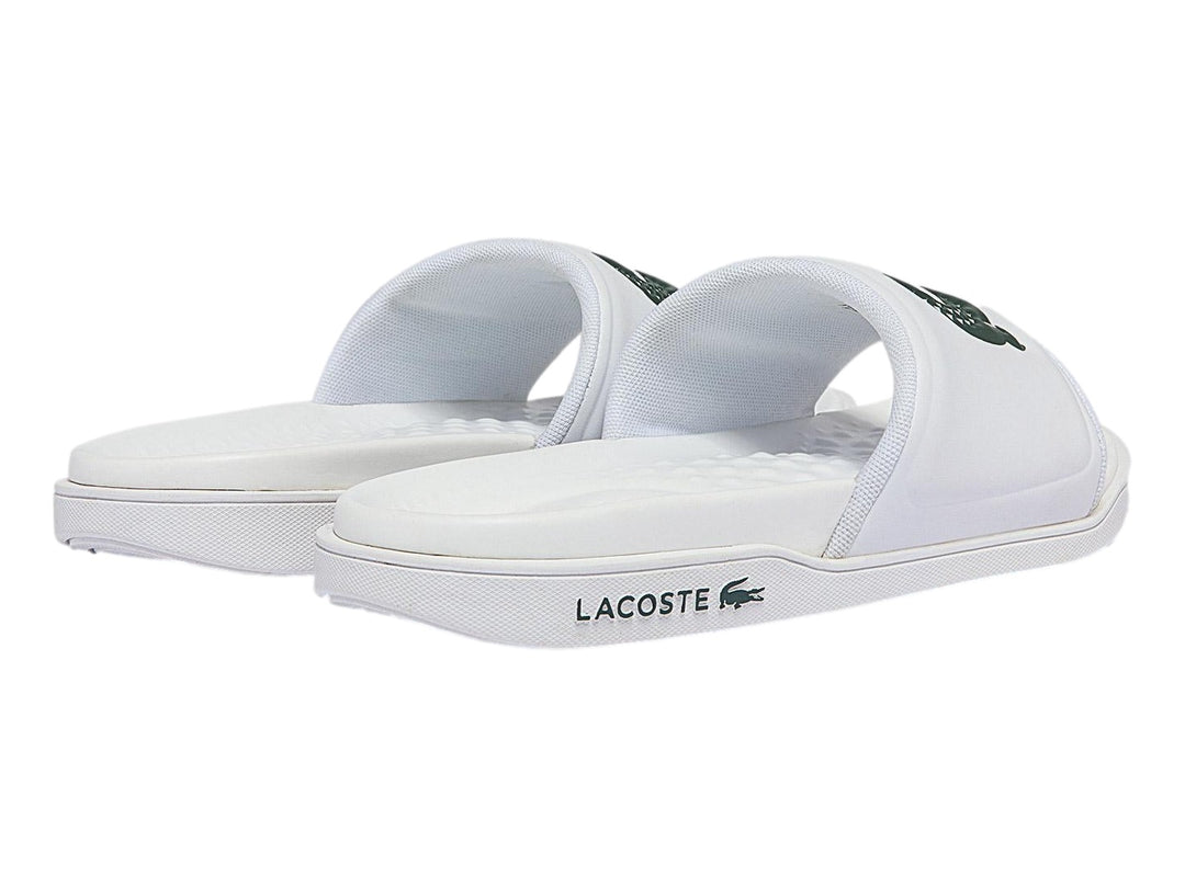 Sandalia deslizante Lacoste de color blanco con logotipo del cocodrilo en verde.