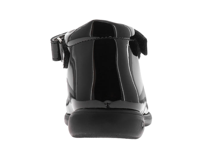 Zapato negro de charol para niña con moño decorativo y correa ajustable.