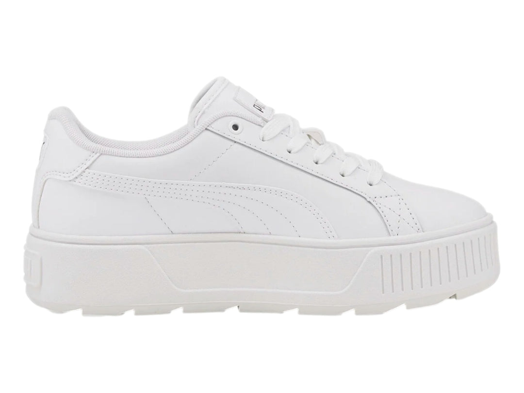 Tenis PUMA blancos con suela de plataforma gruesa y diseño minimalista.