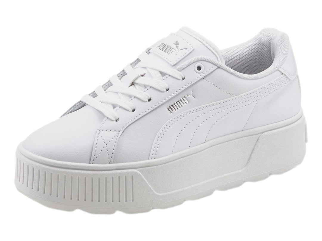 Tenis PUMA blancos con suela de plataforma gruesa y diseño minimalista.