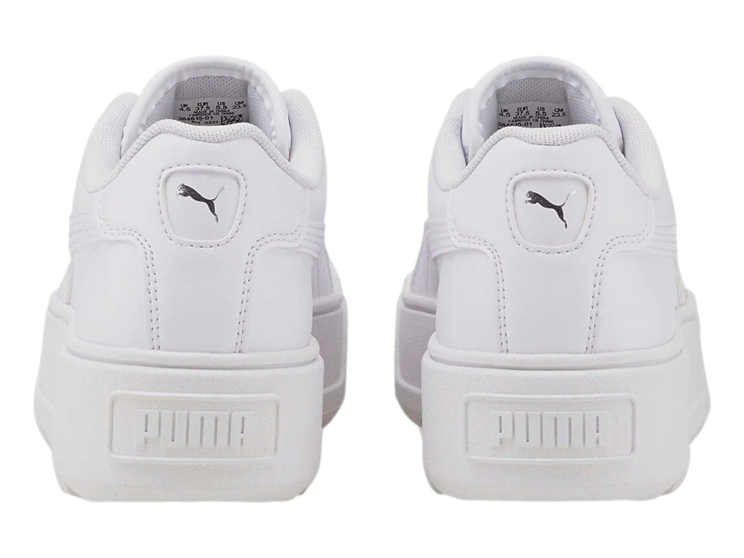 Tenis PUMA blancos con suela de plataforma gruesa y diseño minimalista.