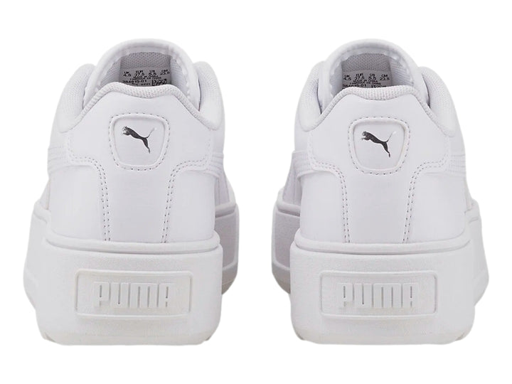Tenis PUMA blancos con suela de plataforma gruesa y diseño minimalista.