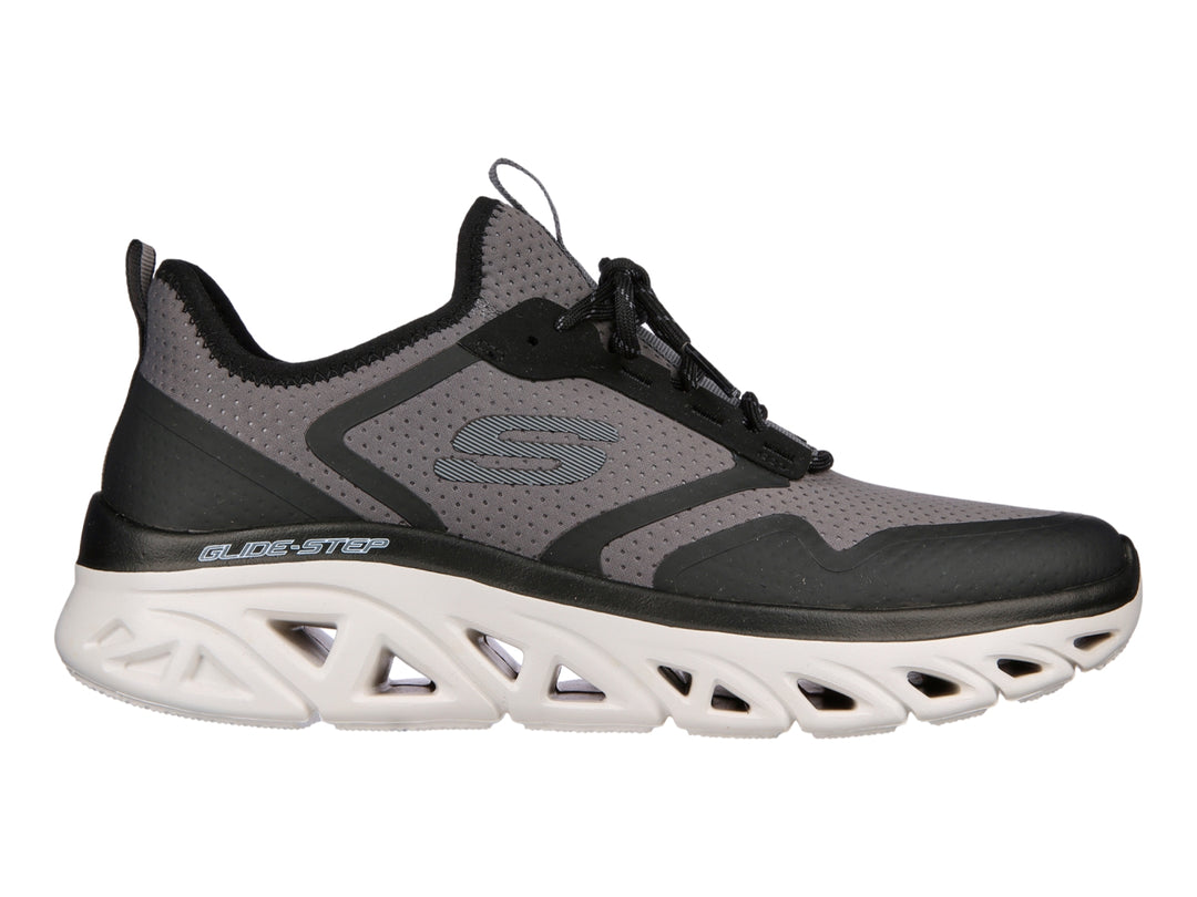 Tenis deportivos Skechers en colores gris y negro con suela blanca tecnológica Glide-Step.