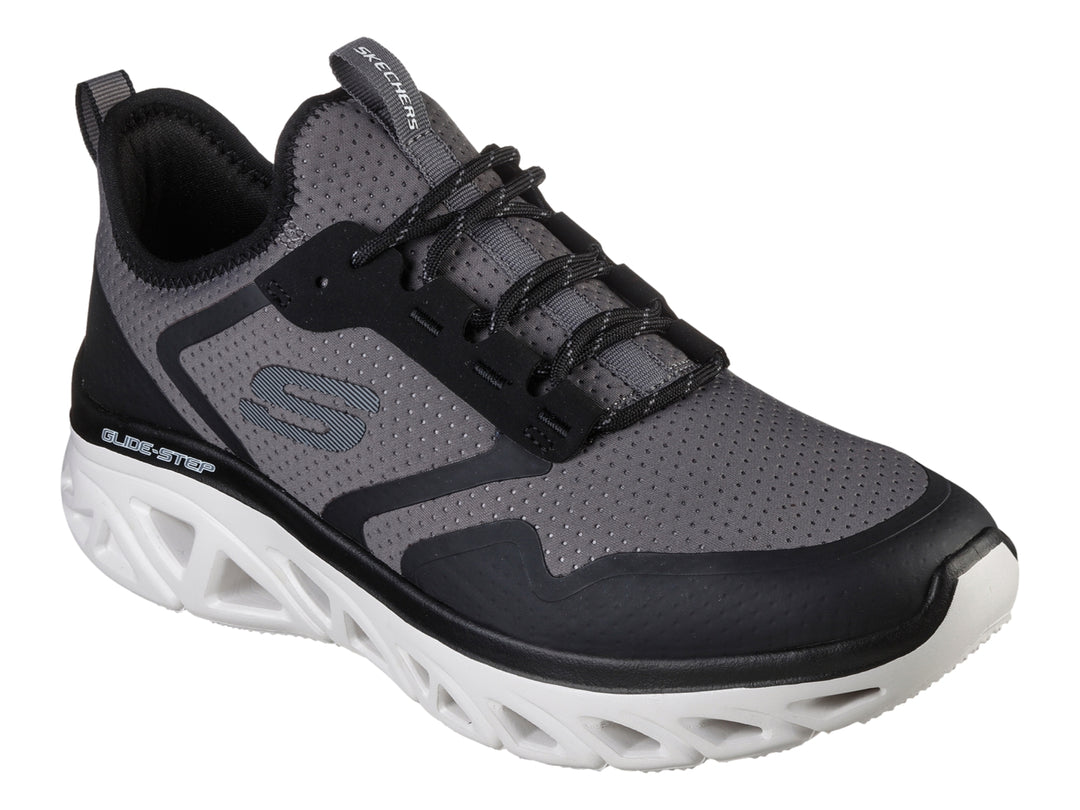 Tenis deportivos Skechers en colores gris y negro con suela blanca tecnológica Glide-Step.