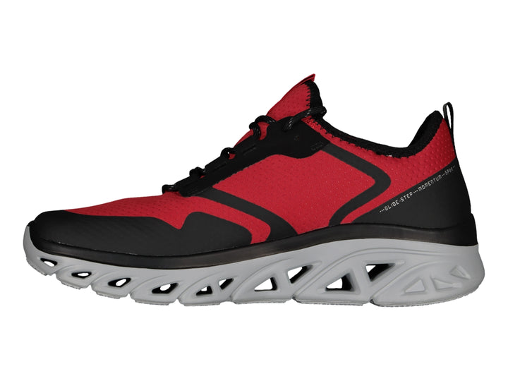 Tenis deportivos Skechers color rojo y negro con suela gris texturizada.