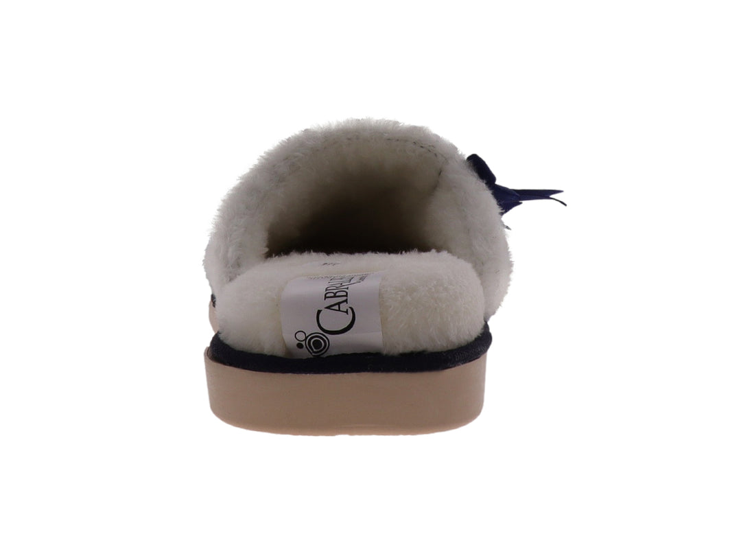 Pantuflas de terciopelo acolchado color marino con interior blanco y un moño decorativo en la parte superior.