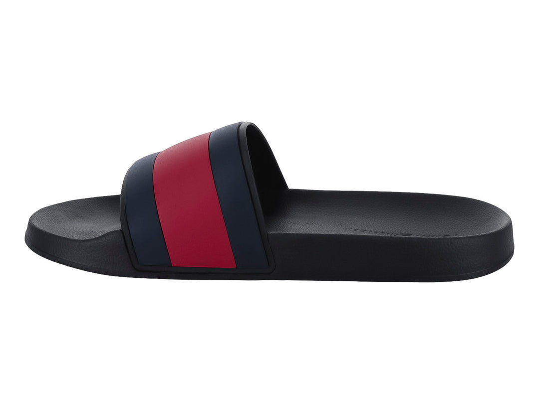 Sandalia slide Tommy Hilfiger color negro con banda tricolor en azul, blanco y rojo.