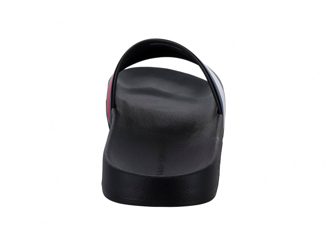 Sandalia slide Tommy Hilfiger color negro con banda tricolor en azul, blanco y rojo.