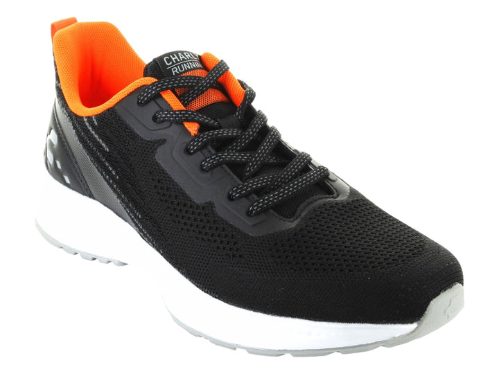 Tenis deportivos Charly color negro con interior naranja y suela blanca.