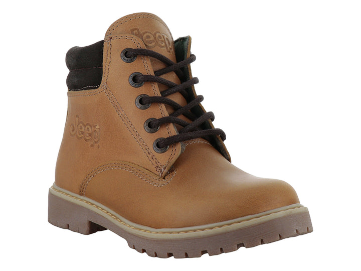 Bota infantil color miel con suela marrón y detalles en gamuza oscura.