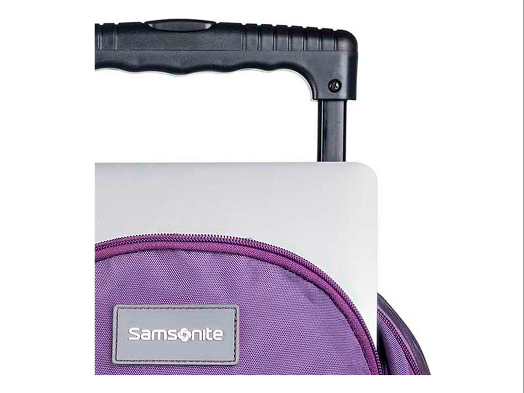 Mochila escolar Samsonite color lila con ruedas y asa extensible negra.