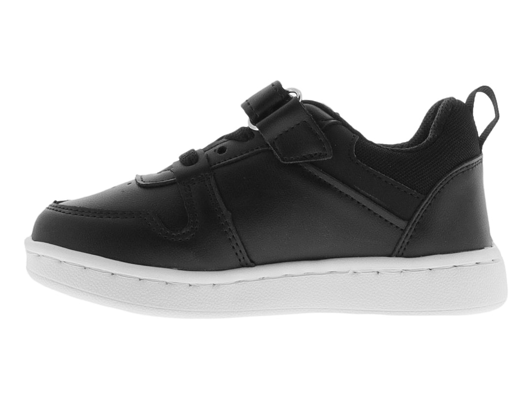 Tenis deportivo infantil color negro con suela y detalles en blanco, cierre de cordones y velcro.