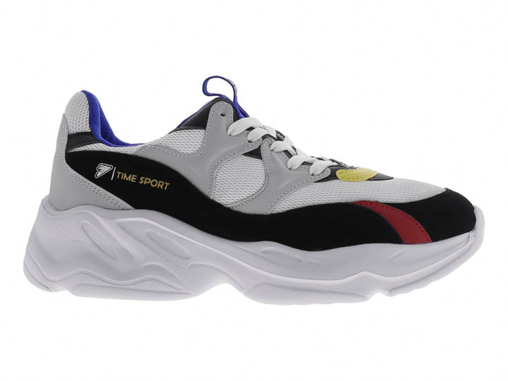 Tenis deportivos chunky color blanco con detalles en negro, azul, rojo y amarillo.