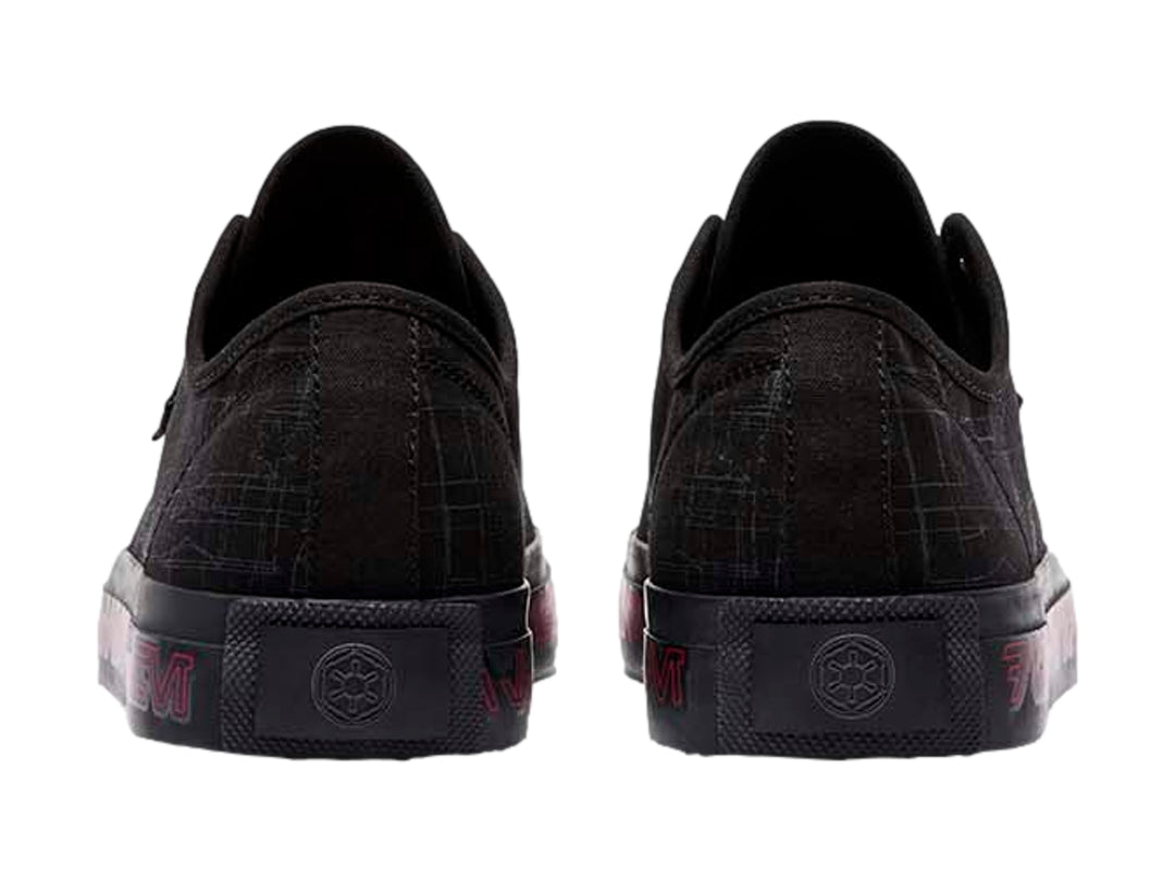 Tenis negros DC Shoes con gráficos grises y letras rojas en la suela.