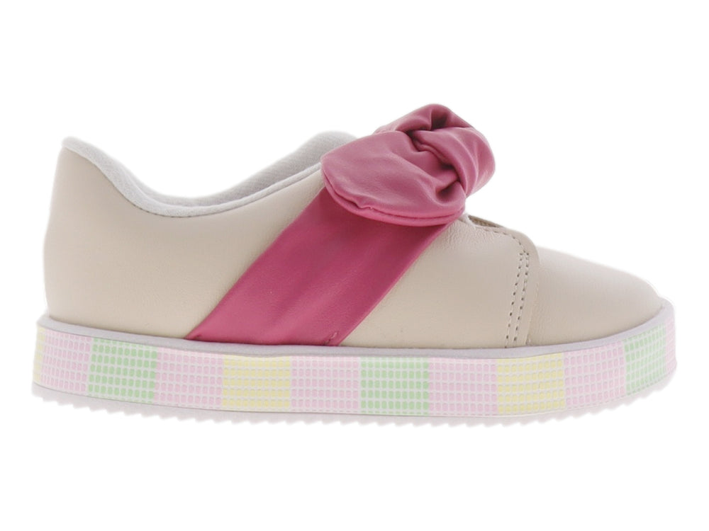 Zapato infantil color crema con un gran moño rosa en la parte superior y suela de plataforma con patrón cuadriculado.