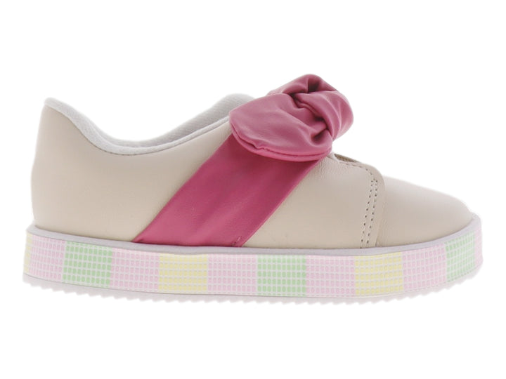 Zapato infantil color crema con un gran moño rosa en la parte superior y suela de plataforma con patrón cuadriculado.