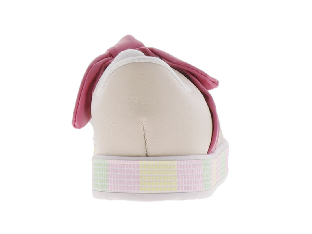Zapato infantil color crema con un gran moño rosa en la parte superior y suela de plataforma con patrón cuadriculado.