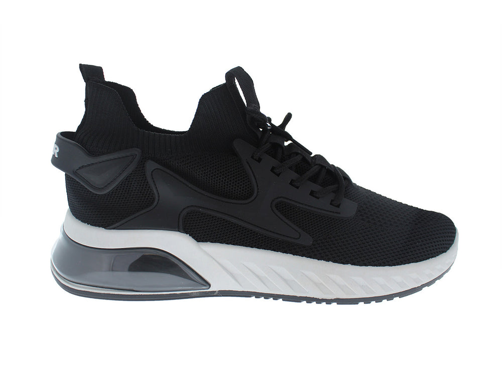 Tenis deportivos Furor color negro con suela blanca y gris, diseño de malla transpirable.