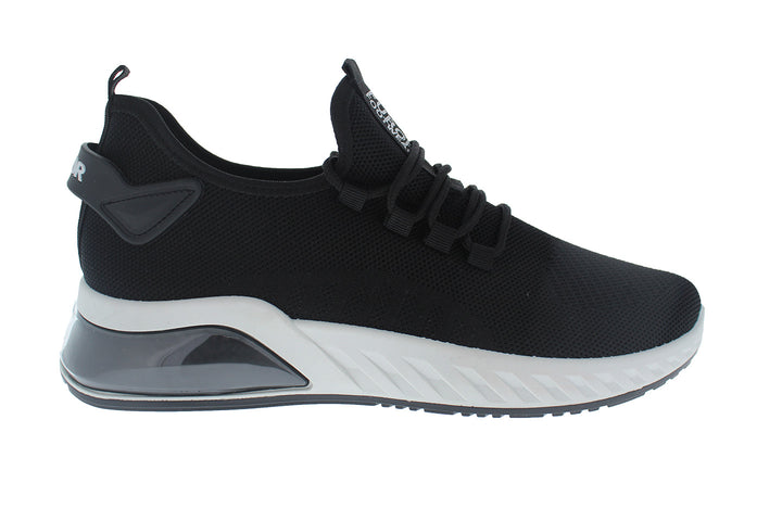 Tenis deportivos Furor de color negro con suela blanca y tejido transpirable.
