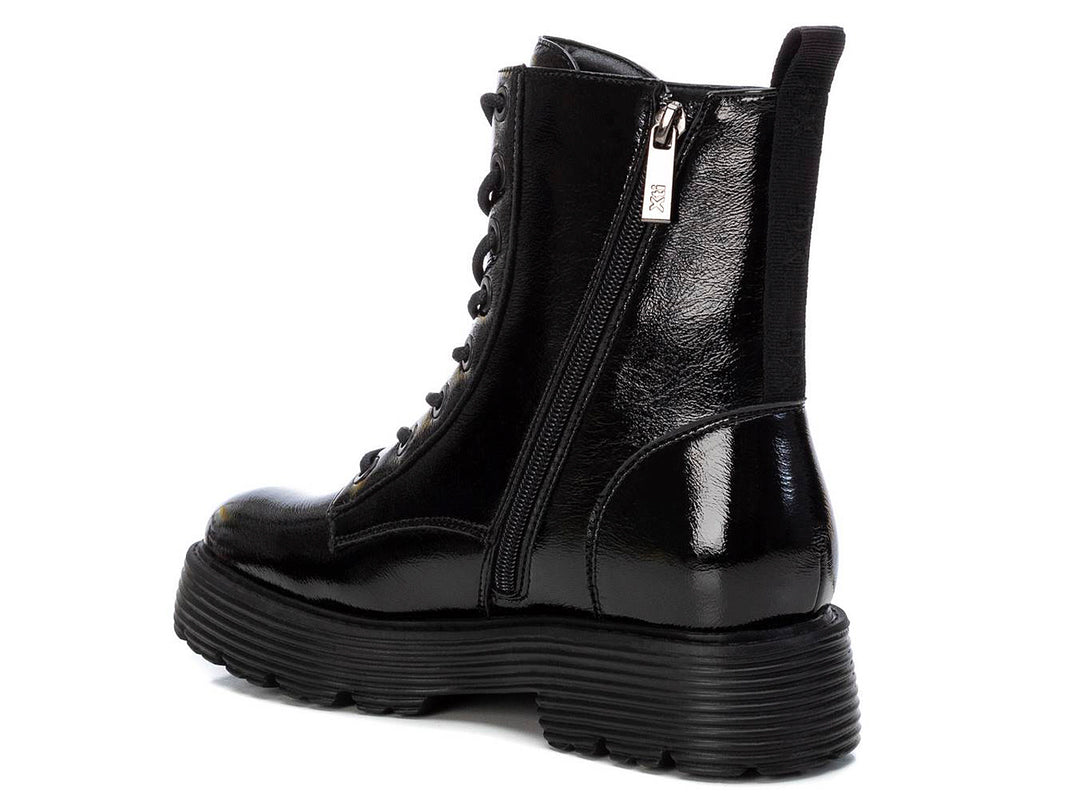 Bota negra de plataforma con acabado brillante y agujetas.