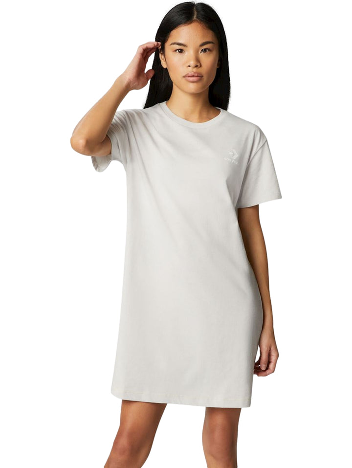 Mujer vistiendo un vestido corto tipo camiseta de color gris claro de la marca Converse.