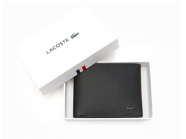 Cartera Lacoste de cuero negro con textura grabada y logo discreto en la esquina inferior derecha.