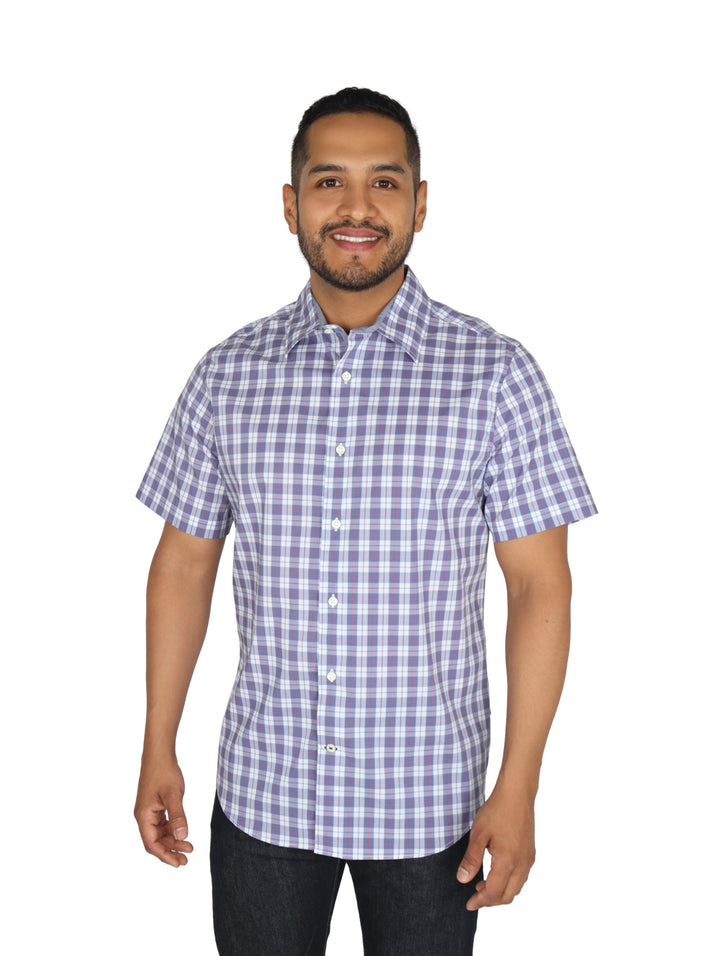 Hombre vistiendo una camisa de manga corta con estampado de cuadros en color azul y blanco.
