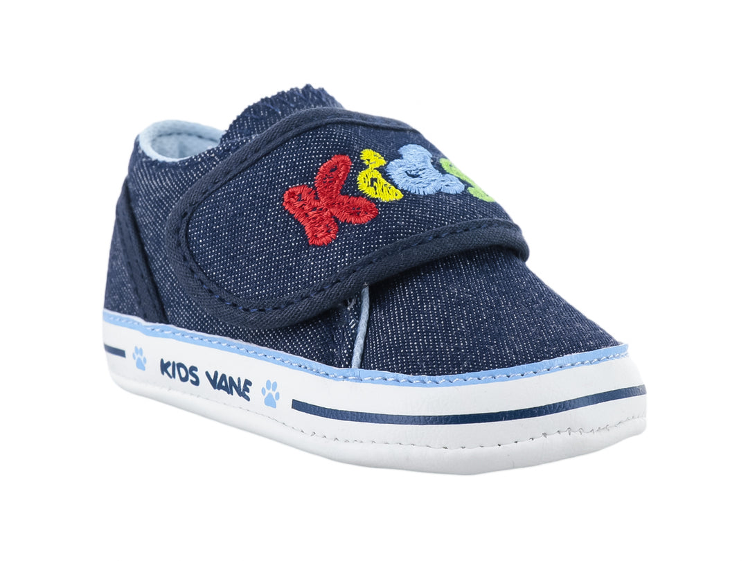 Zapato infantil color azul marino de tela con bordados coloridos y suela blanca.