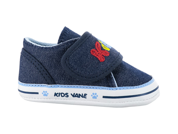 Zapato infantil color azul marino de tela con bordados coloridos y suela blanca.