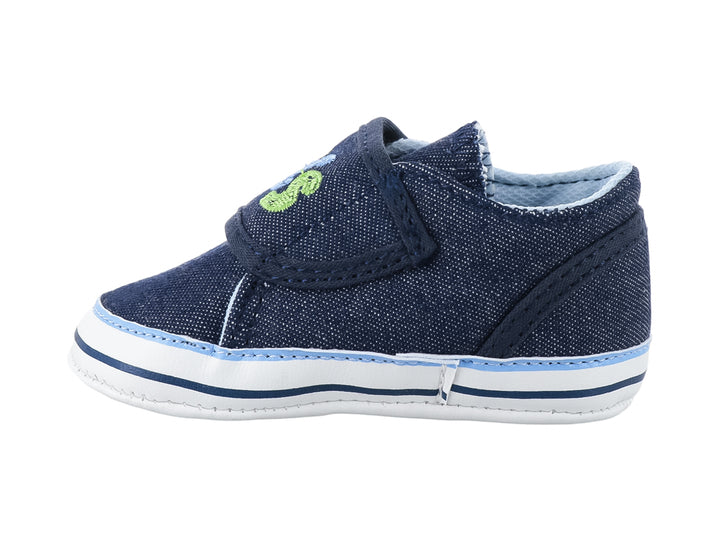 Zapato infantil color azul marino de tela con bordados coloridos y suela blanca.