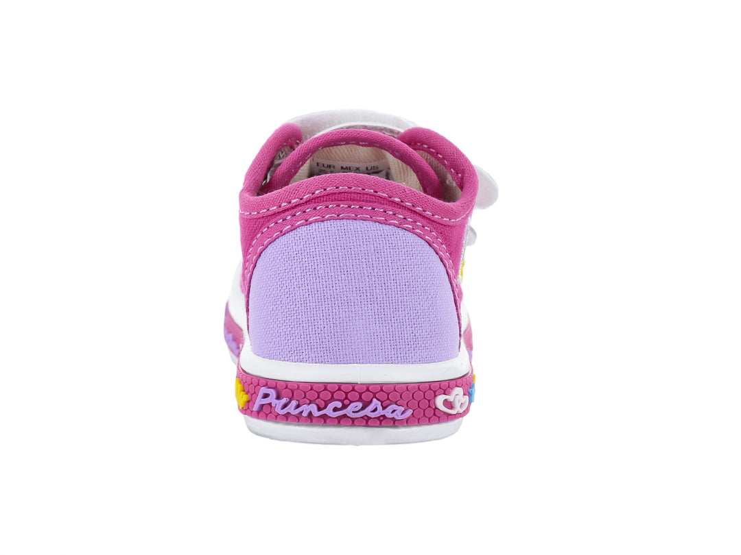 Zapato infantil color fucsia con detalles brillantes, suela blanca y adornos de coronas y estrellas.