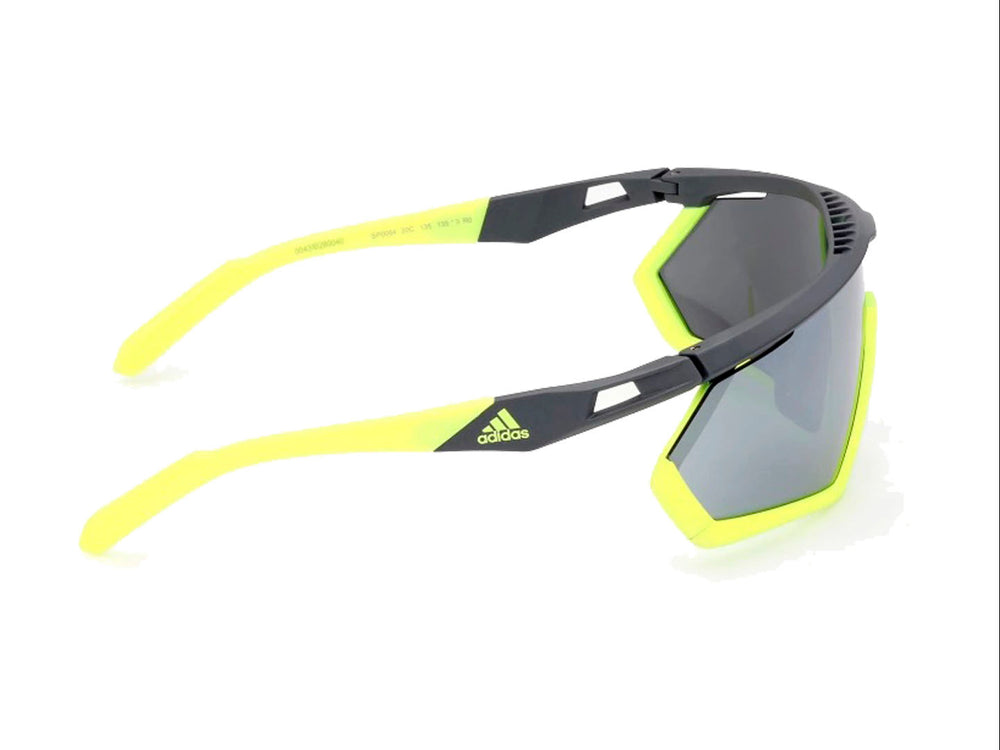 Lentes de sol deportivos Adidas color gris y amarillo con diseño envolvente.