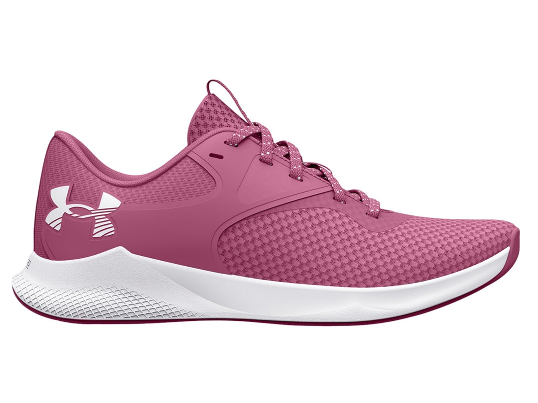 Tenis deportivos Under Armour color rosa con suela blanca y logotipo blanco lateral.