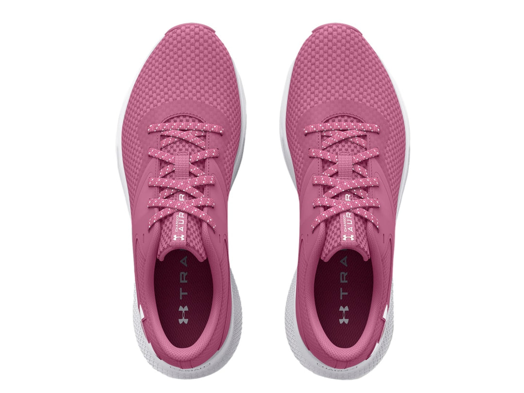 Tenis deportivos Under Armour color rosa con suela blanca y logotipo blanco lateral.