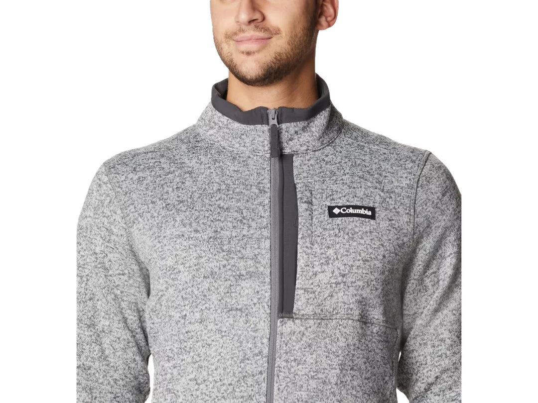 Hombre vistiendo sudadera Columbia color gris jaspeado con cierre frontal y cuello alto.