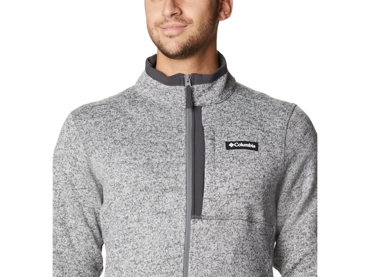 Hombre vistiendo sudadera Columbia color gris jaspeado con cierre frontal y cuello alto.