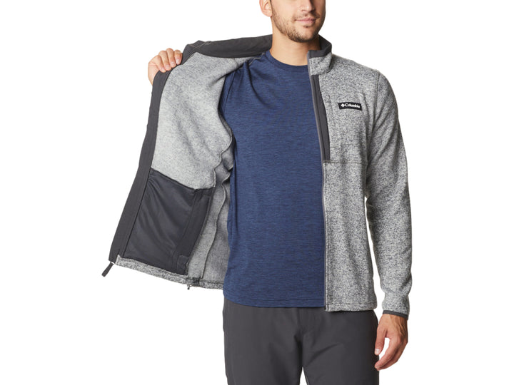Hombre vistiendo sudadera Columbia color gris jaspeado con cierre frontal y cuello alto.