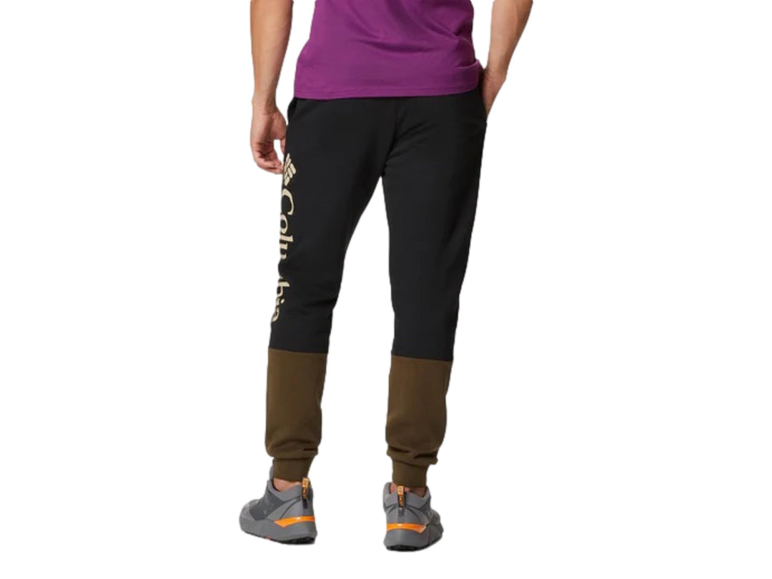 Pantalones jogger Columbia color-block en colores verde oliva y negro con puños elásticos.