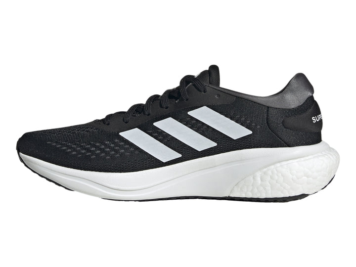 Tenis deportivos Adidas Supernova 2.0 en color negro con franjas y suela blanca.