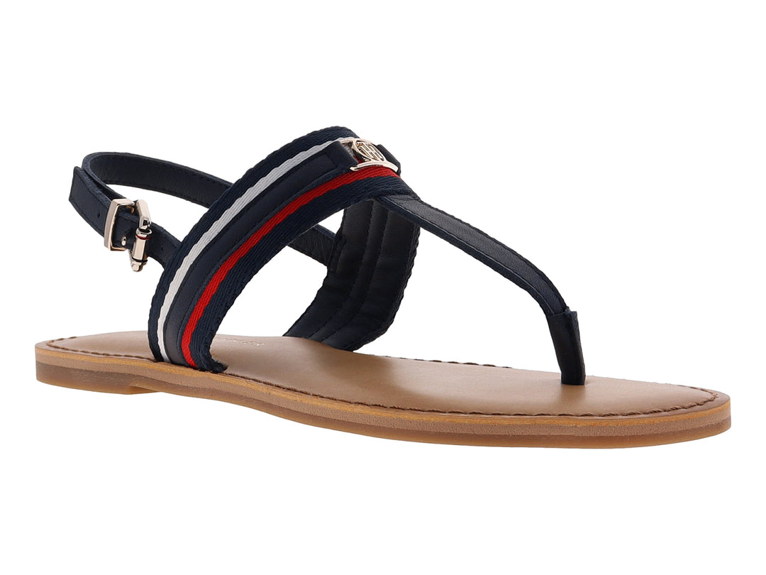 Sandalia plana Tommy Hilfiger azul marino con detalles en rojo y blanco y suela color beige.