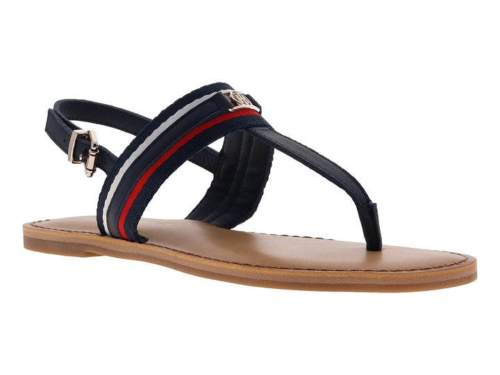Sandalia plana Tommy Hilfiger azul marino con detalles en rojo y blanco y suela color beige.
