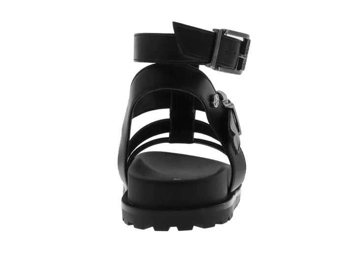 Sandalia negra de plataforma para niño con correas ajustables y suela track.