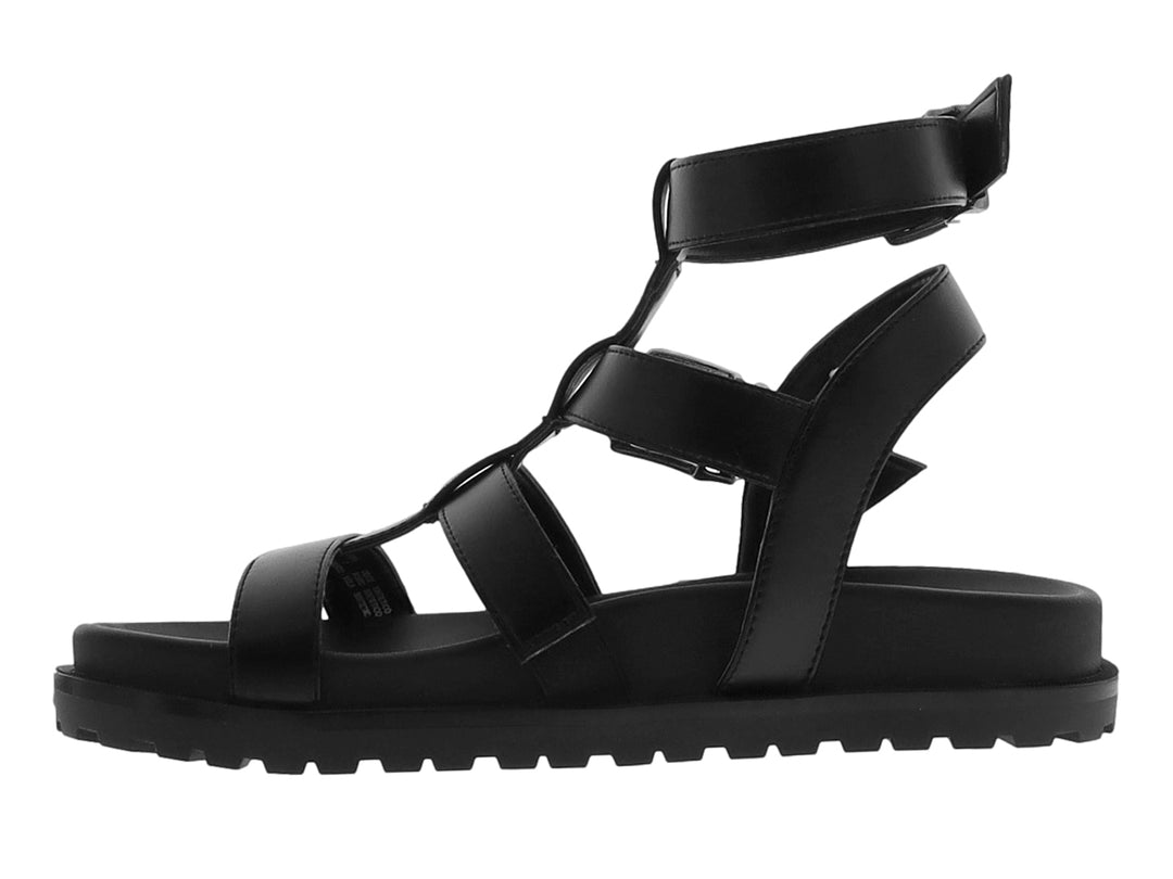 Sandalia negra de plataforma para niño con correas ajustables y suela track.