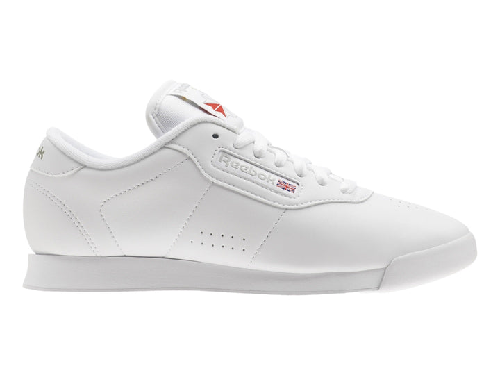 Tenis deportivos Reebok color blanco con suela blanca y detalles en el lateral.