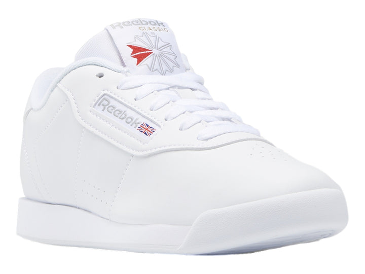 Tenis deportivos Reebok color blanco con suela blanca y detalles en el lateral.