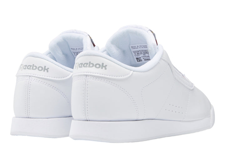 Tenis deportivos Reebok color blanco con suela blanca y detalles en el lateral.