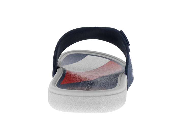 Sandalia tipo slide para niño en color azul marino con franjas blanca y roja y suela blanca.