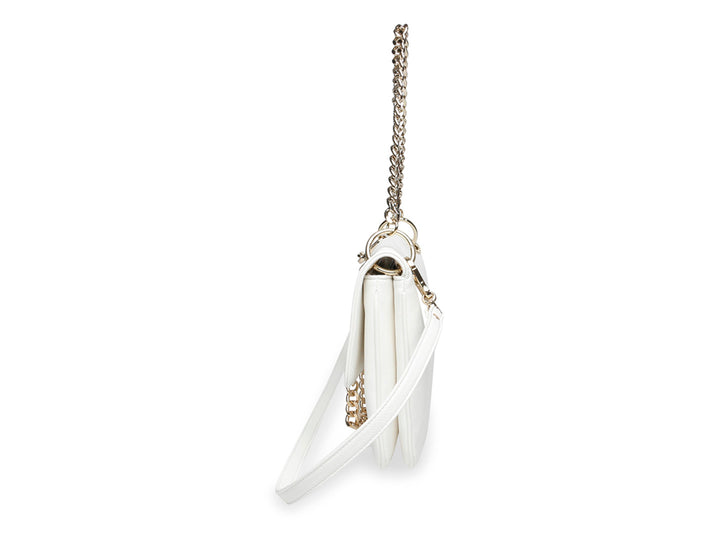 Bolso blanco de Steve Madden con correa de cadena dorada y cierre metálico frontal.